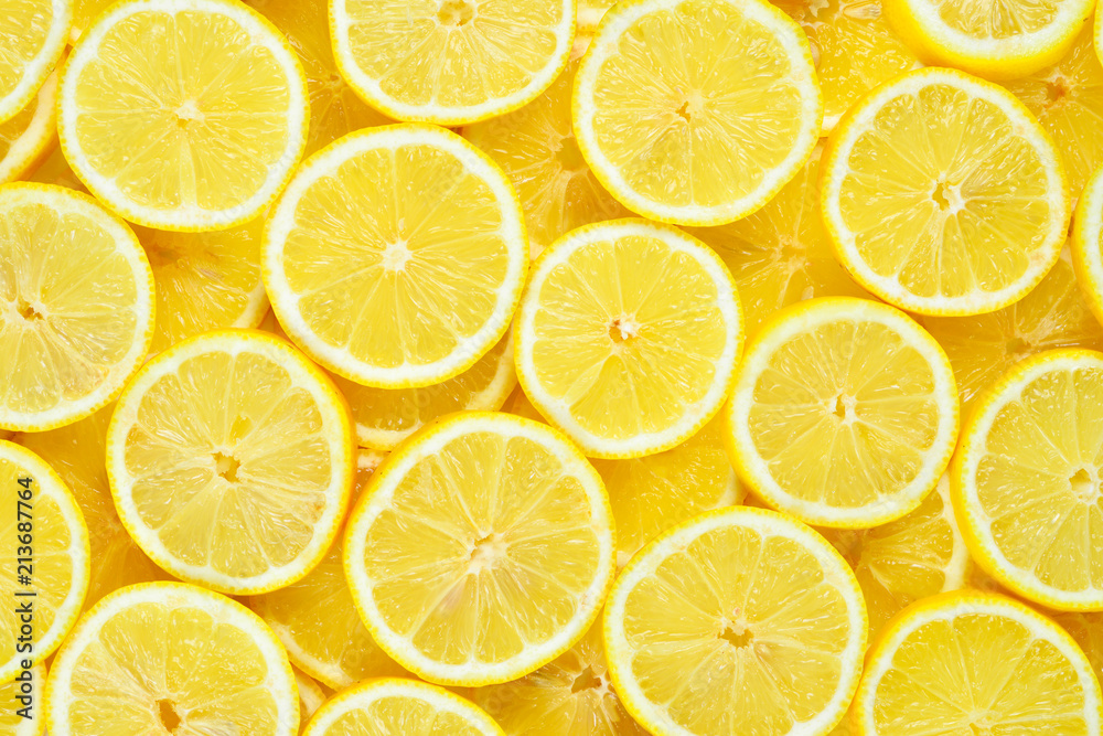 A slices of fresh juicy yellow lemons.  Texture background, pattern.