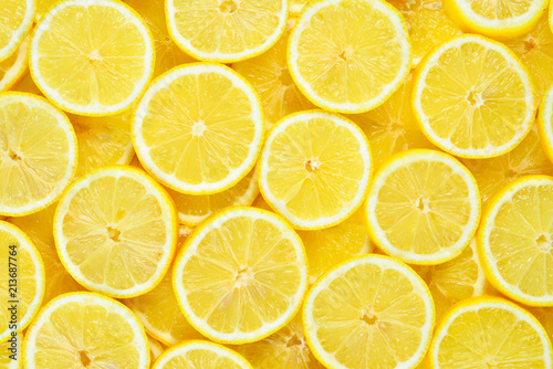 A slices of fresh juicy yellow lemons.  Texture background, pattern. photo