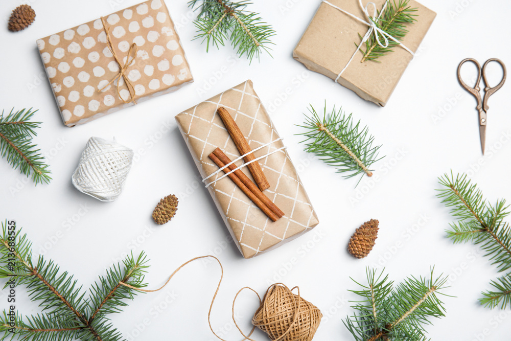 Composition with Christmas tree branches and gift boxes on white background Composition with Christmas tree branches and gift boxes on white background