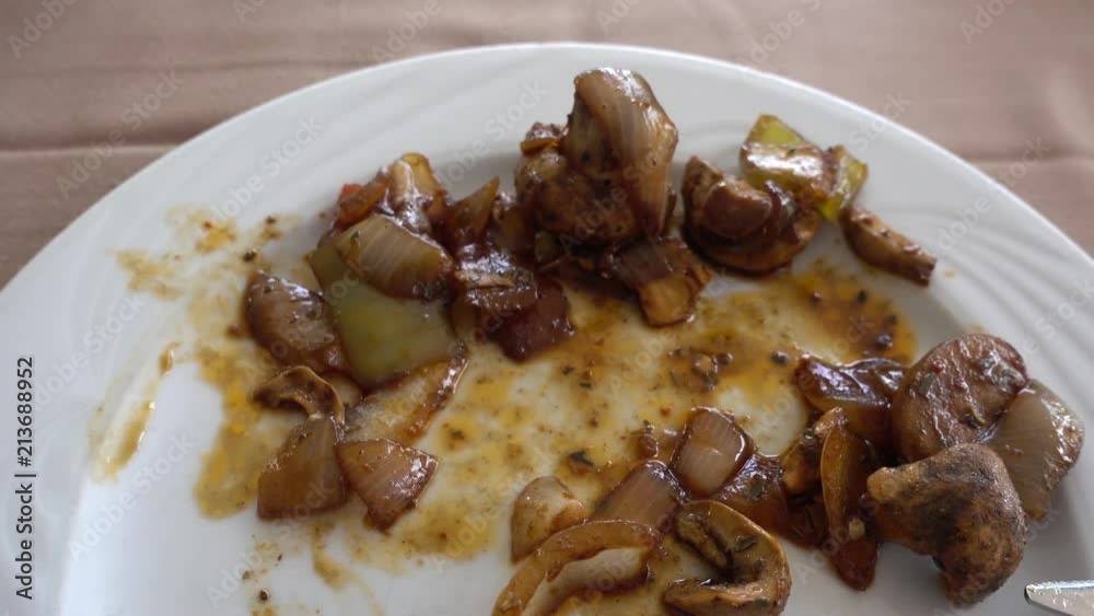 Point of view of a person who eats fried mushrooms in a Buffet restaurant. A man with a fork and a knife eats champignons. Eating and tasty and healthy food concept. Point of view of a person who eats fried mushrooms in a Buffet restaurant. A man with a fork and a knife eats champignons. Eating and tasty and healthy food concept.