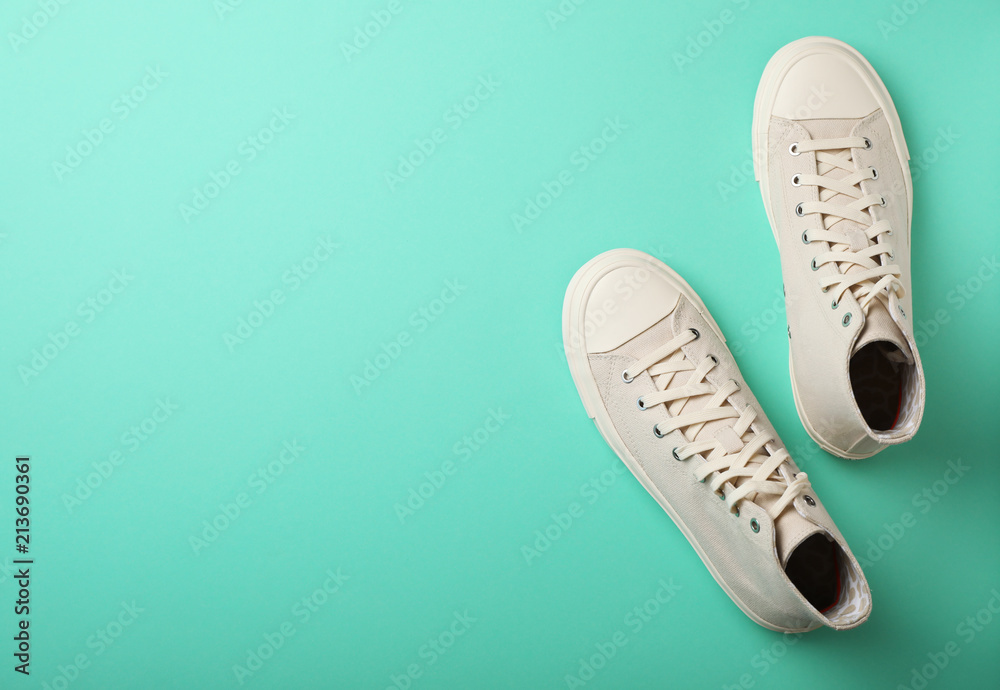 Pair of stylish sneakers on color background, top view Pair of stylish sneakers on color background, top view