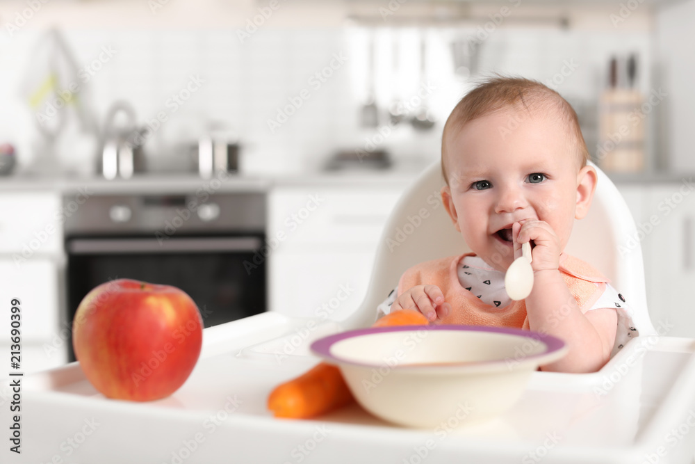 Adorable little child having breakfast in highchair indoors. Healthy baby food Adorable little child having breakfast in highchair indoors. Healthy baby food