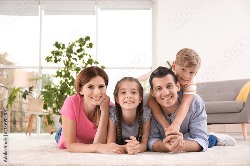 Happy family with cute children at home