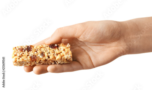 Woman holding grain cereal bar on white background. Healthy snack © New Africa