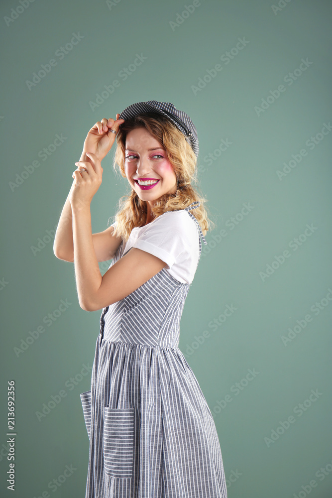 Beautiful young woman posing on color background. Summer fashion