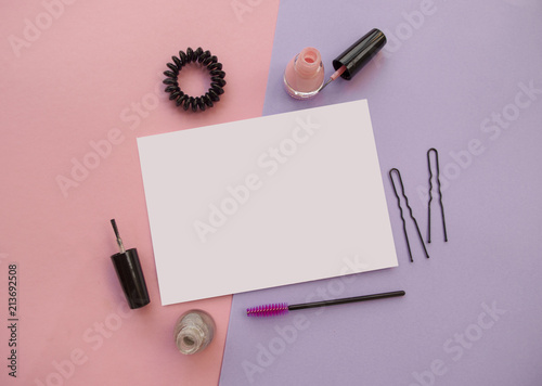Set of cosmetics on pink and violet background.