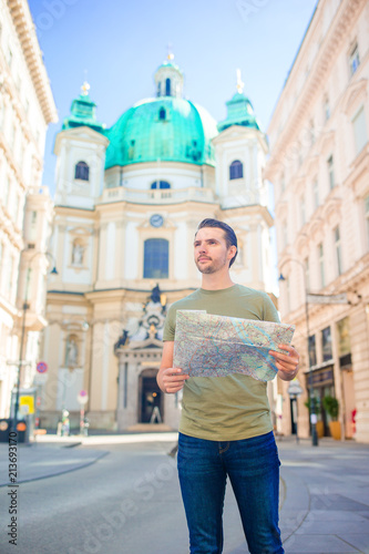 Photography Man tourist with a city map and backpack in Europe street