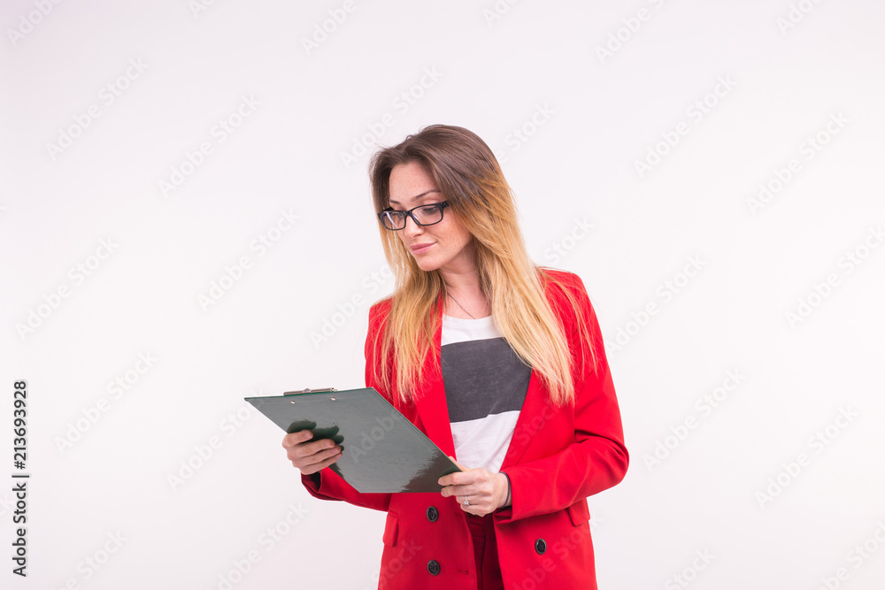 Portrait of young business woman in red jacket with paper clip in hands. Portrait of young business woman in red jacket with paper clip in hands.