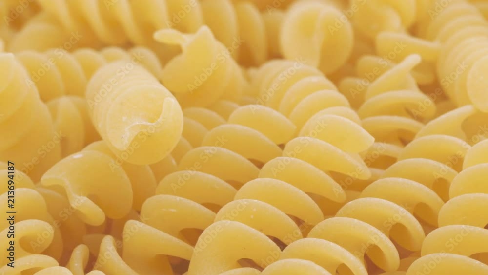 Food background, dried fusilli rotating, macro shot (loopable)
