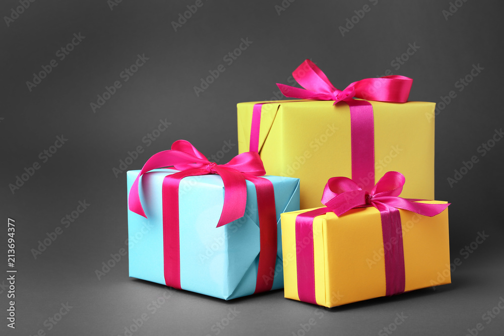 Beautiful gift boxes with ribbons on gray background Beautiful gift boxes with ribbons on gray background