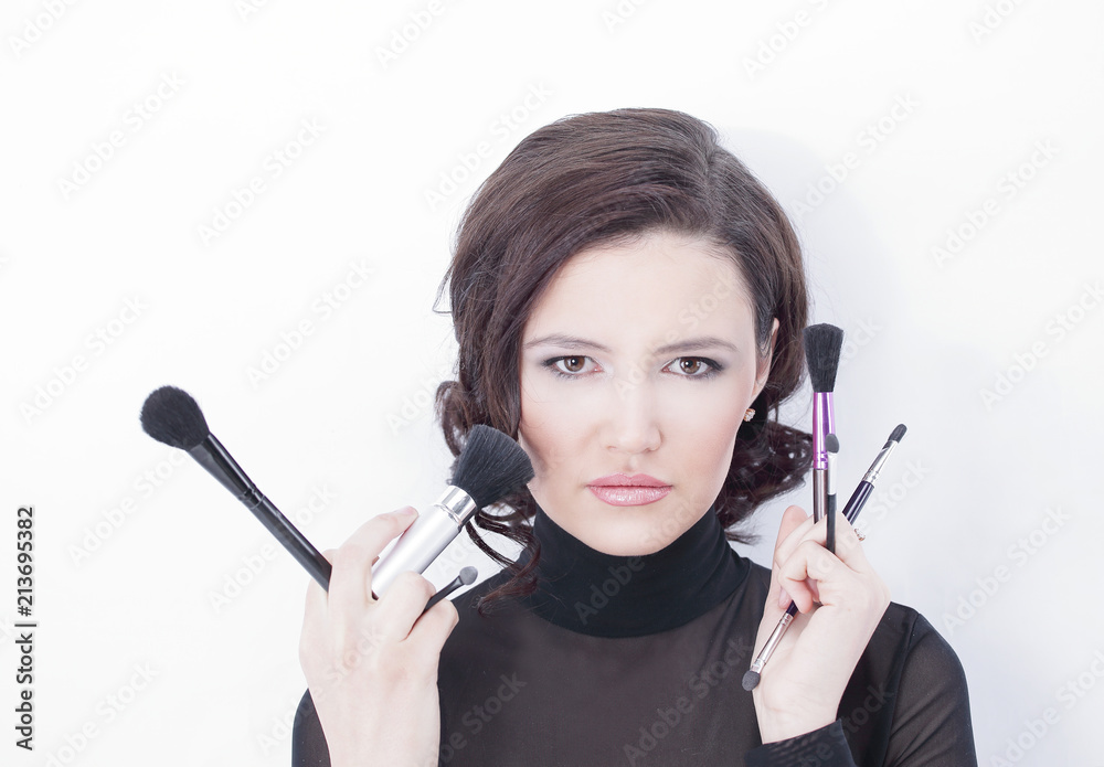 beautiful young woman holding make-up brushes beautiful young woman holding make-up brushes