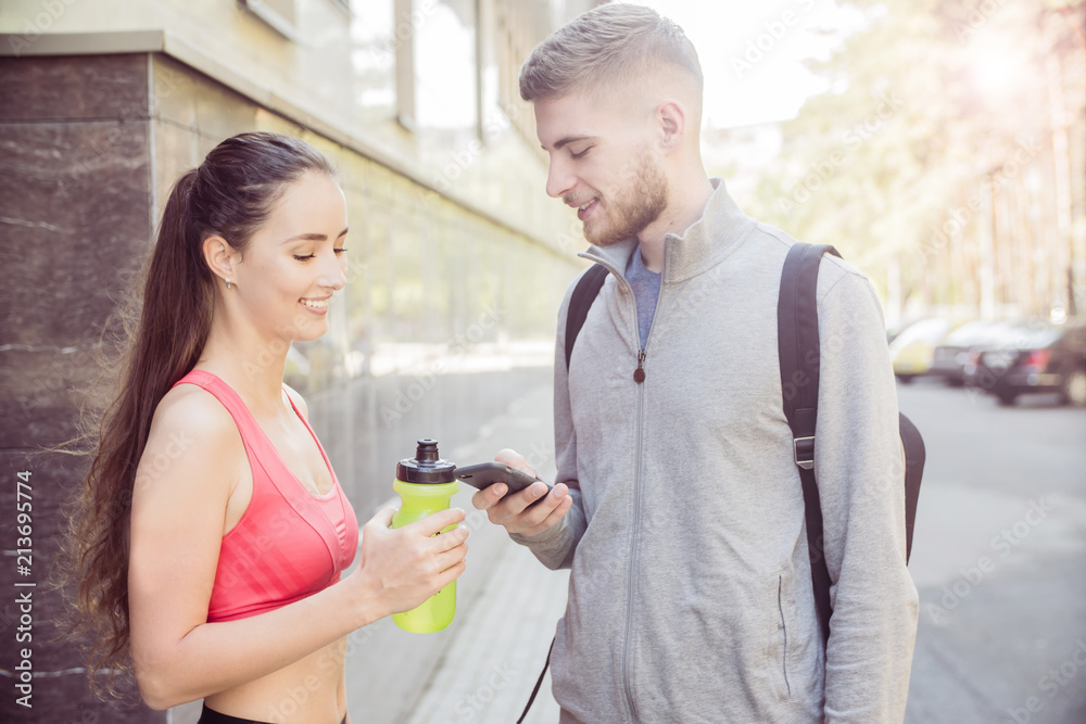 young couple runners talking on the street, the concept of a healthy lifestyle