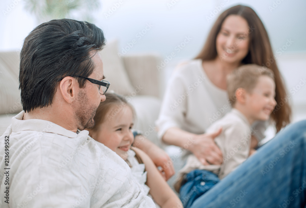 close up.parents and their small children sitting on the couch close up.parents and their small children sitting on the couch
