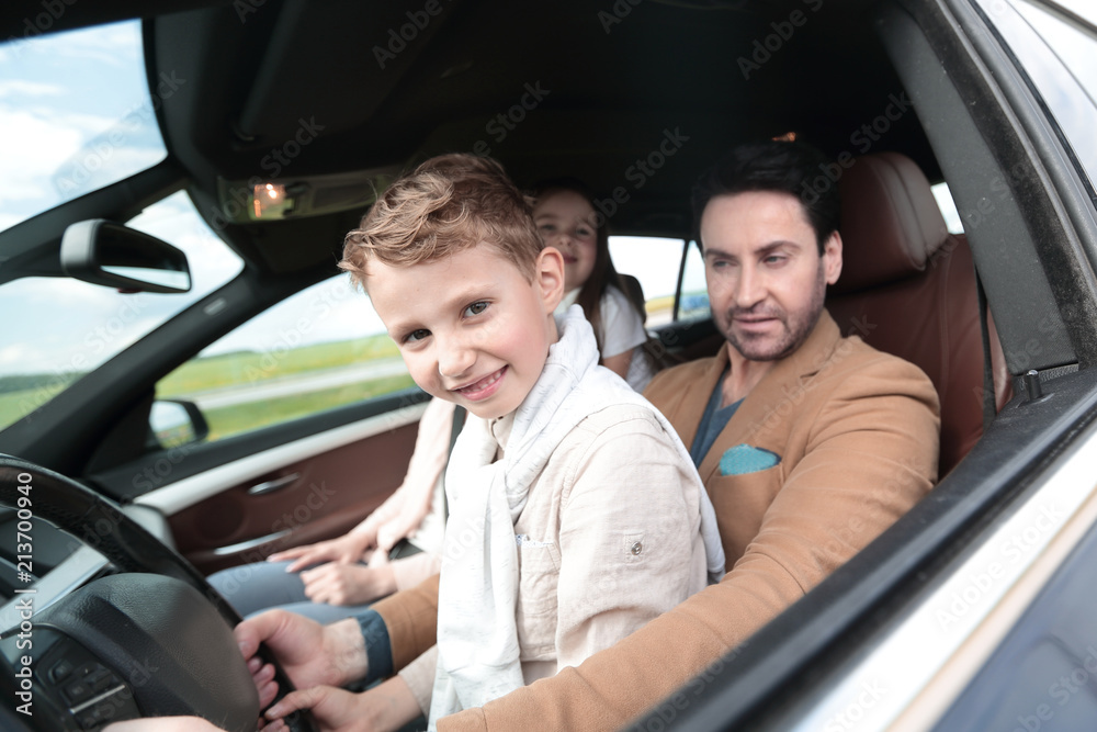 father and son driving a car