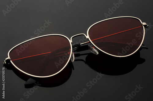sunglasses cat's eye with red glasses in metal frame isolated on black