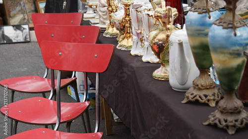 Vases, ceramic objects and vintage chairs for sale in a used market in Rome