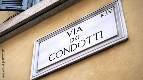 Street plate in marble of the famous Roman shopping street Via dei Condotti, in perspective view from below photo