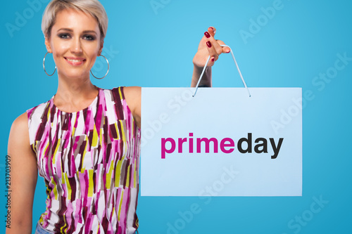 Shopping woman holding color bags isolated on blue background in black friday holiday. Summer shopping sale concept.