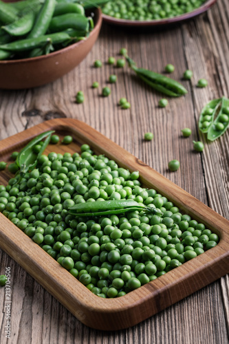Fresh organic green peas on rustic wooden table, harvest time