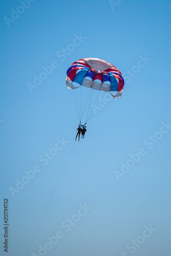 parasailing on a parachute fly two people
