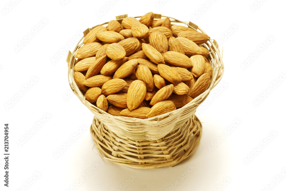 Almonds in Cane basket isolated on white background