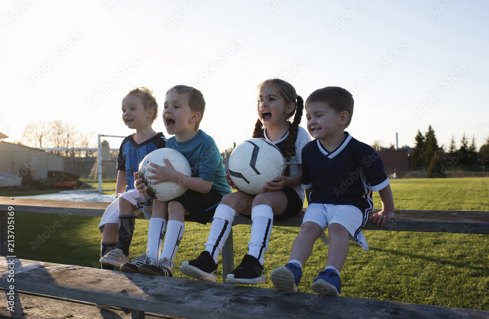 © Cavan Images - Children screaming while looking away at park against clear sky during sunset © Cavan Images - Children screaming while looking away at park against clear sky during sunset