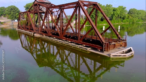 Beautiful railroad train trestle bridge reflected in still waters.
