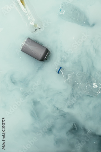 top view of smoke, can and plastic bottles flowing in water, environment protection concept © LIGHTFIELD STUDIOS