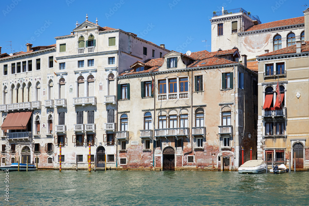 Venice old buildings facades and the grand canal in a sunny day in Italy