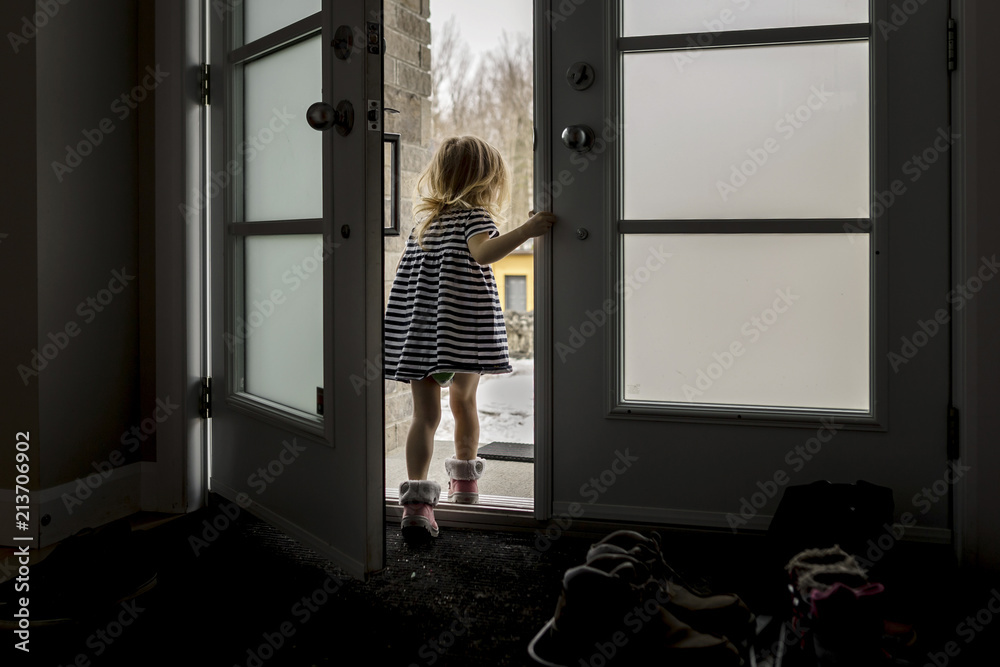 Rear view of girl standing at entrance in house Rear view of girl standing at entrance in house