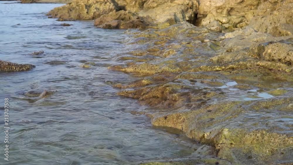Calm sea waves slowly splashing on the rock. Calm sea waves slowly splashing on the rock.