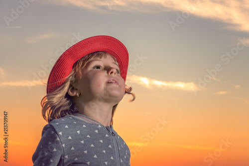 Cute girl with red hat portrait at dusk
