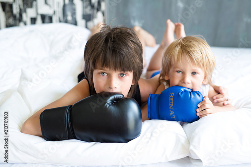 Two cute brothers play and frolic at home. Boxing. Amazing emotions
