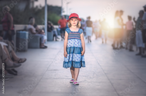 Little girl walking on a seaside promenade
