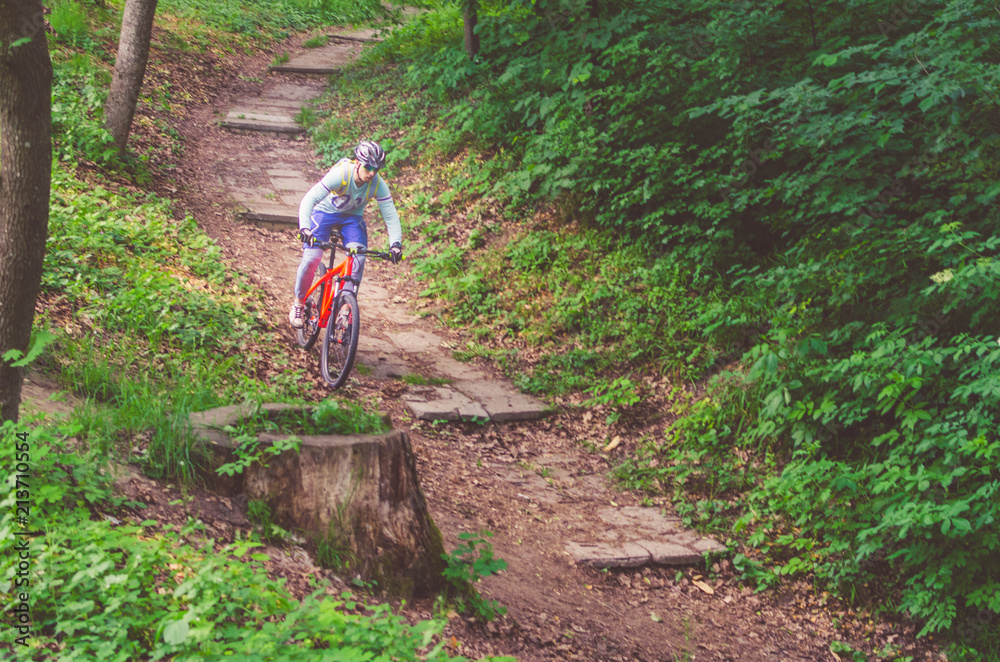 A cyclist in a helmet is riding off-road