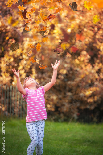 Girl catching leaves in autumn