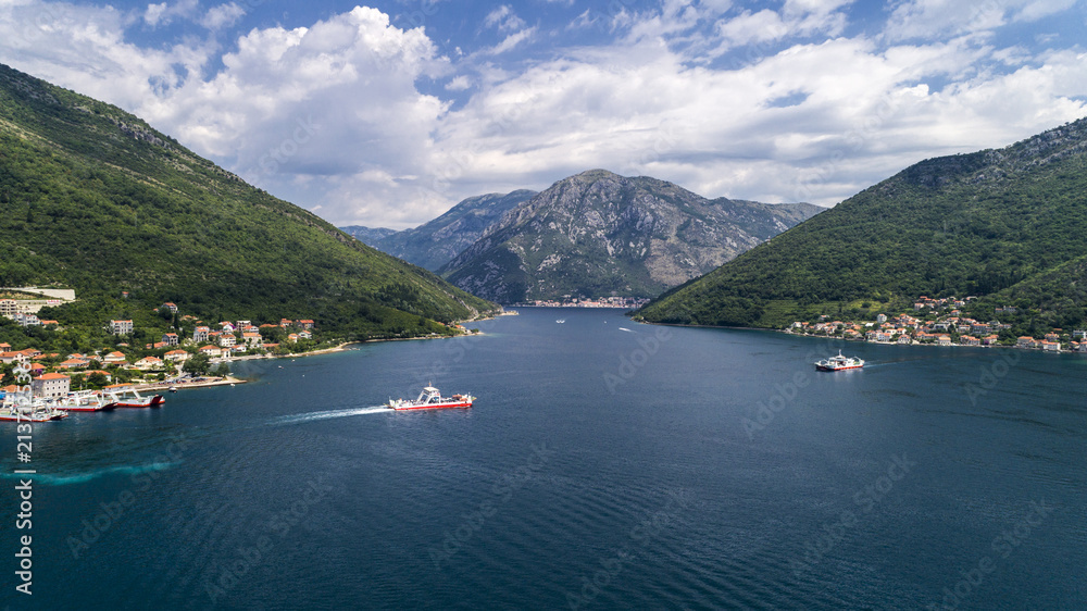 Aerial beautiful view from above to Kotor Bay and regular passenger ferry from Lepetane to Kamenari by a sunny afternoon