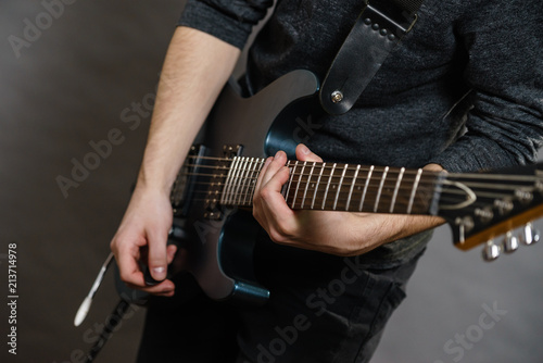 Male hands playing electric guitar