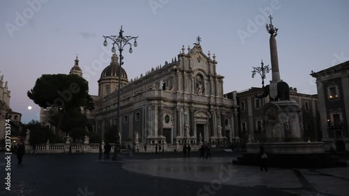 Time lapse of the “Elephant Square” of Catania, and its Dome / Cathedral of Saint Agata at sunset during a sunny winter day. (Italian: Piazza Elefante e Duomo). Catania, Sicily, Italy. 04 Dec 2017 photo