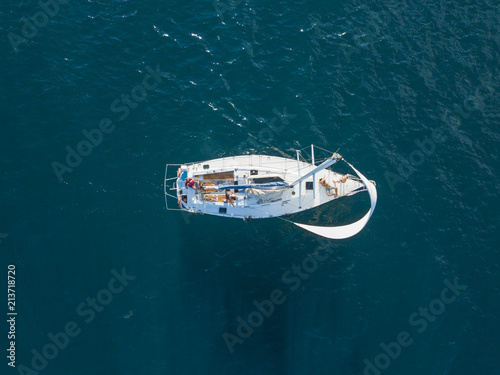 aerial photo of sailboat yacht top view, isolated on the sea texture. participant of sea regatta © Mihail