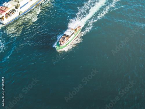 aerial of peple relax and sun tanning in the fast motor boat top view in the summer sea © Mihail