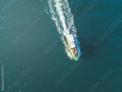 aerial of peple relax and sun tanning in the fast motor boat top view in the summer sea