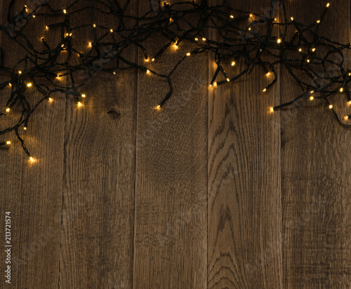 Christmas Light or Garland Lights on Wood Background photo