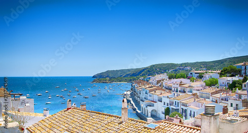View on Street in Cadaques, Catalonia, Spain near of Barcelona. Scenic old town with nice beach and clear blue water in bay. Famous tourist destination in Costa Brava with Salvador Dali landmark photo