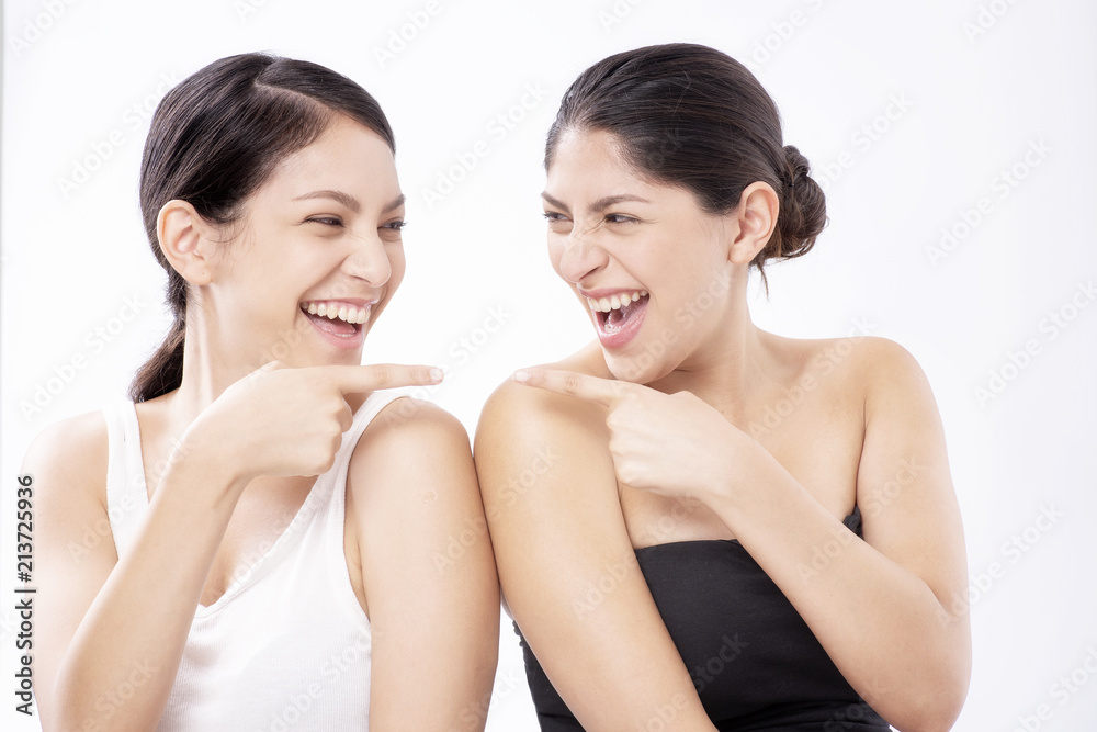 Two girls beautiful woman face close up studio on white background Two girls beautiful woman face close up studio on white background