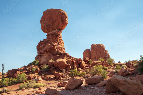 The iconic Balanced Rock stands in sharp relief against an electric blue summer sky in Arches National Park