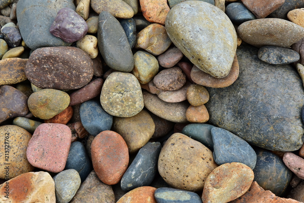 Stones of different shapes and sizes. Gravel, cobblestones form a background. Material for construction Stones of different shapes and sizes. Gravel, cobblestones form a background. Material for construction