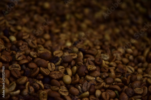 Coffee beans texture. An invigorating background for coffee lovers with blur copy space