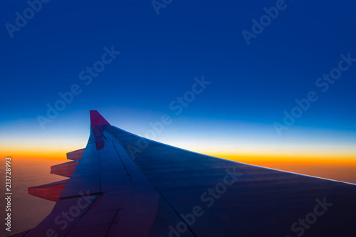 Sunset sky from the airplane window at height 35,000 feet. © Pina