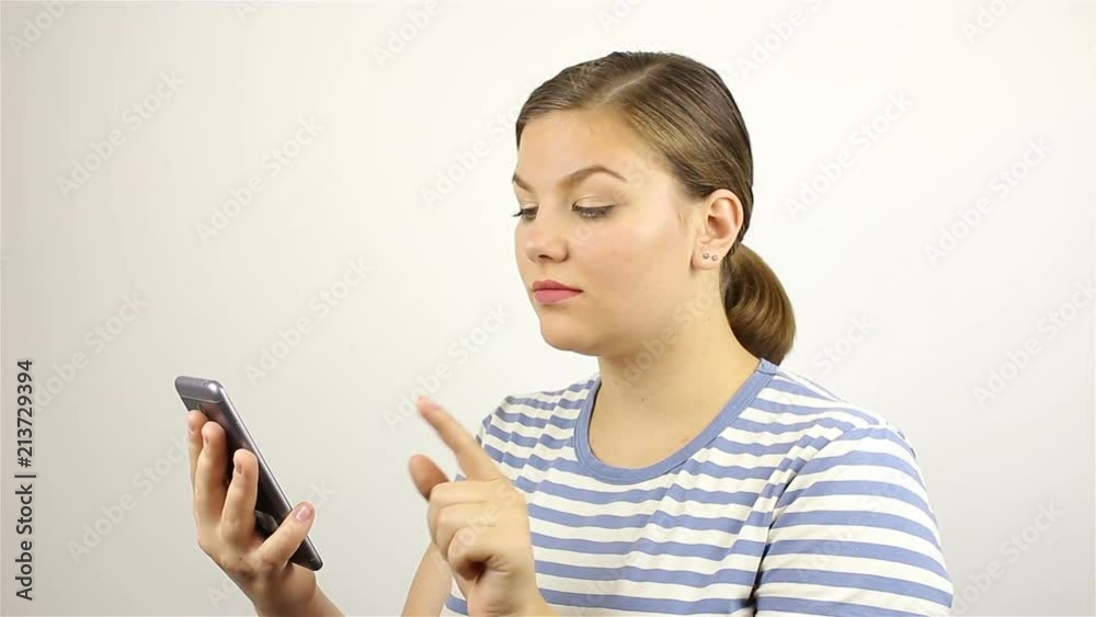 Young beautiful woman hand writing SMS, texting on smartphone. Young beautiful woman hand writing SMS, texting on smartphone.